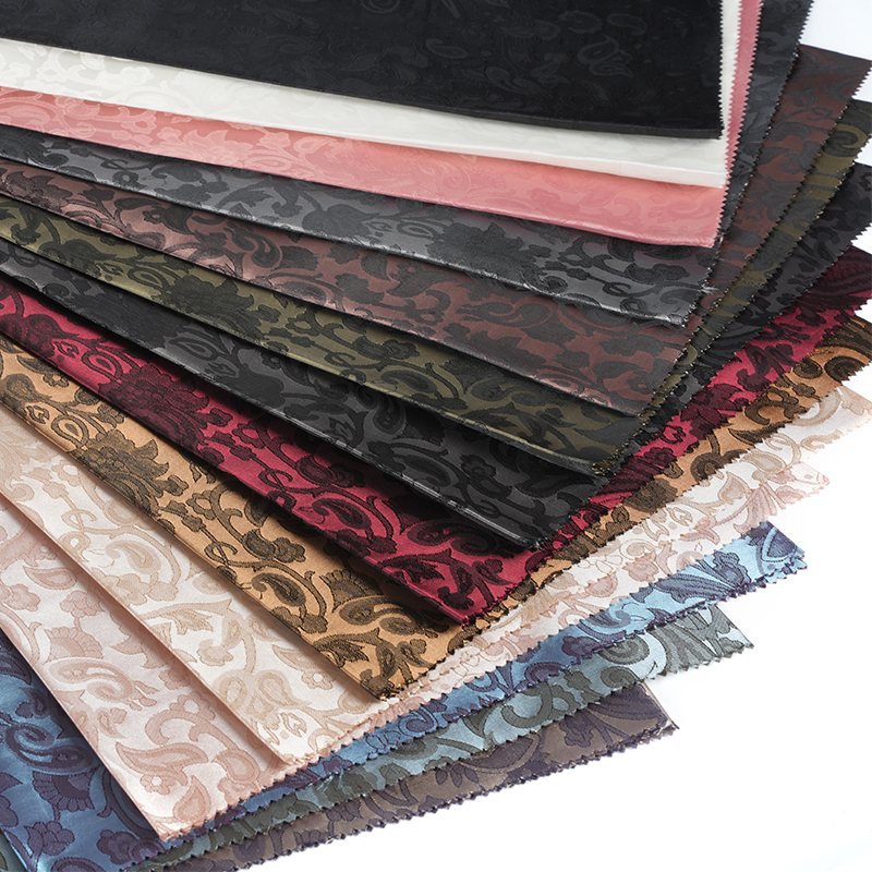 Jacquard med bågad lutblomma i polyester